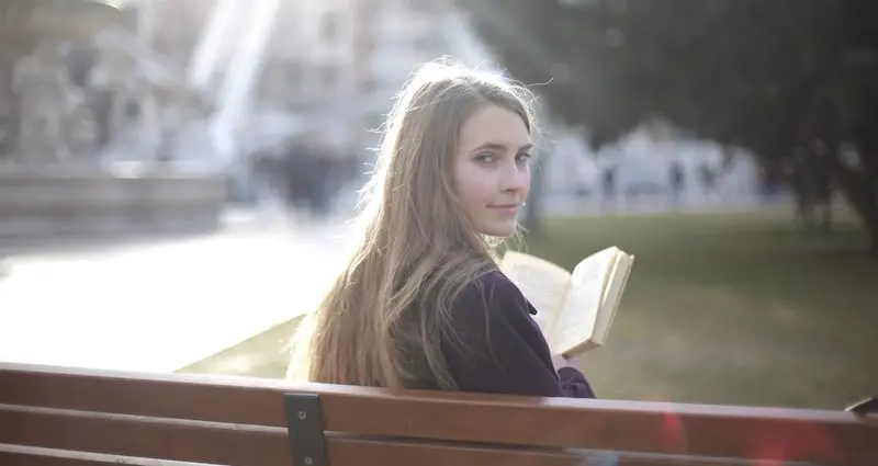 woman studying on bench